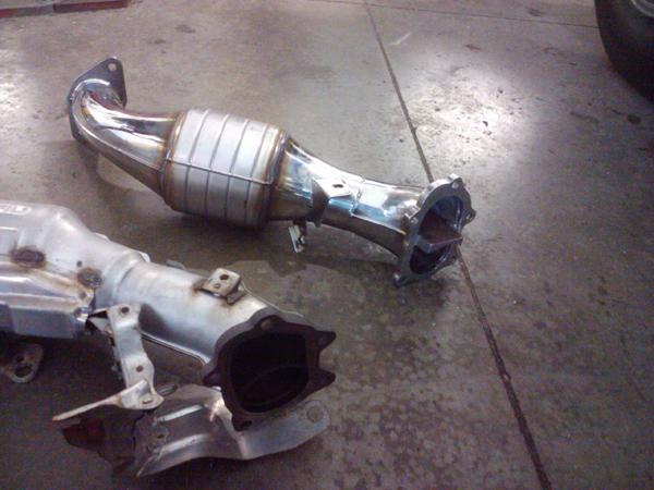 OEM shorty downpipe (left) and Prodrive catted shorty downpipe (right) Subaru WRX STi 2006
